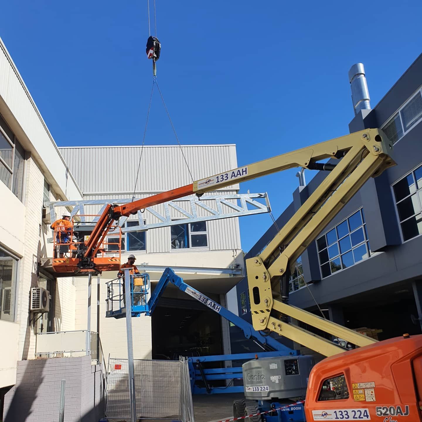A Lift is Being Used to Lift a Crane Over a Building — Proweld Steel Fabrication In Shellharbour, NSW