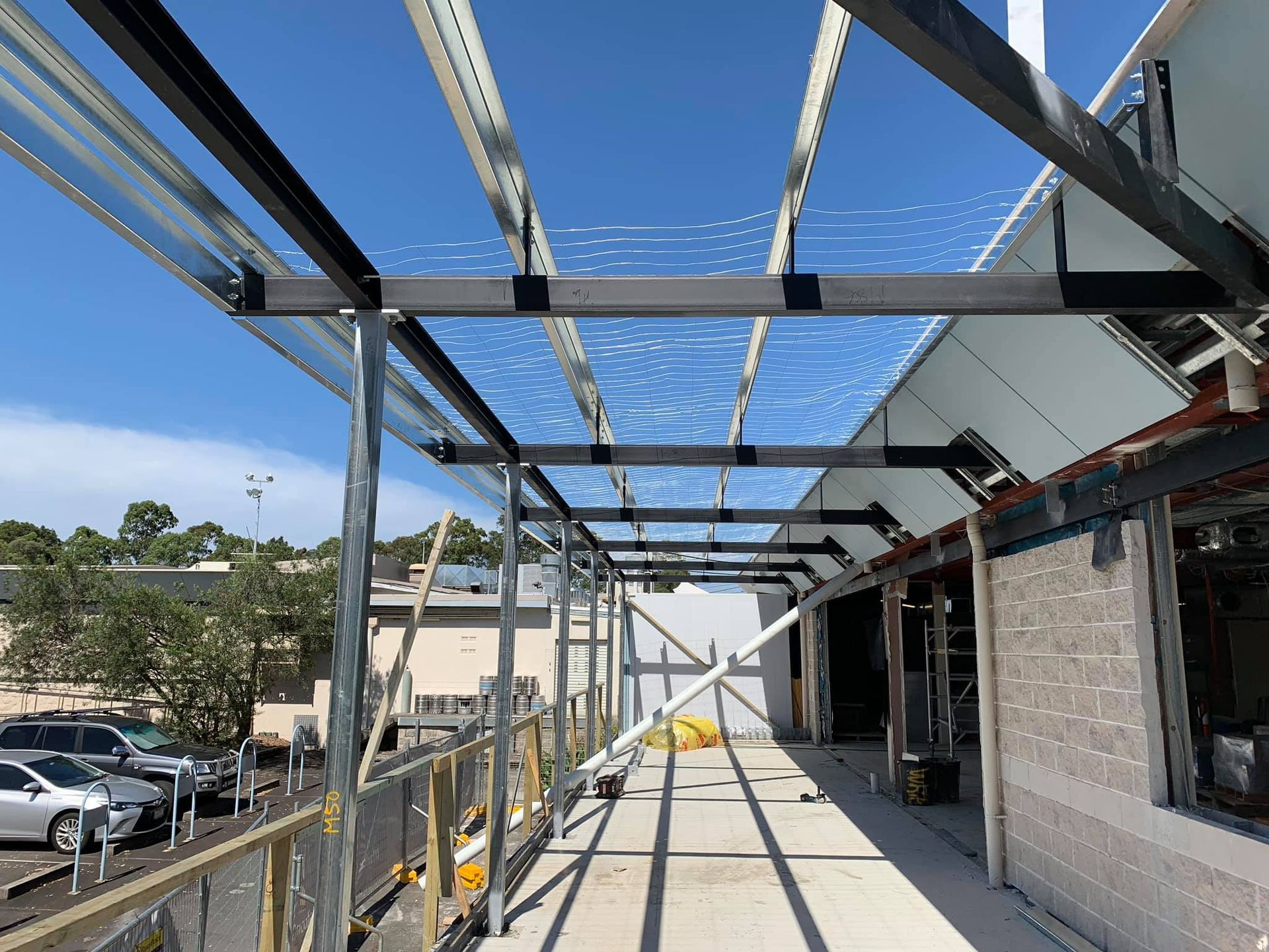 A Metal Structure is Being Built on Top of a Building — Proweld Steel Fabrication In Sydney, NSW
