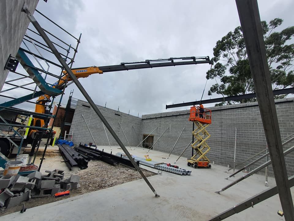 A Crane Lifting a Steel Beam — Proweld Steel Fabrication In Sydney, NSW