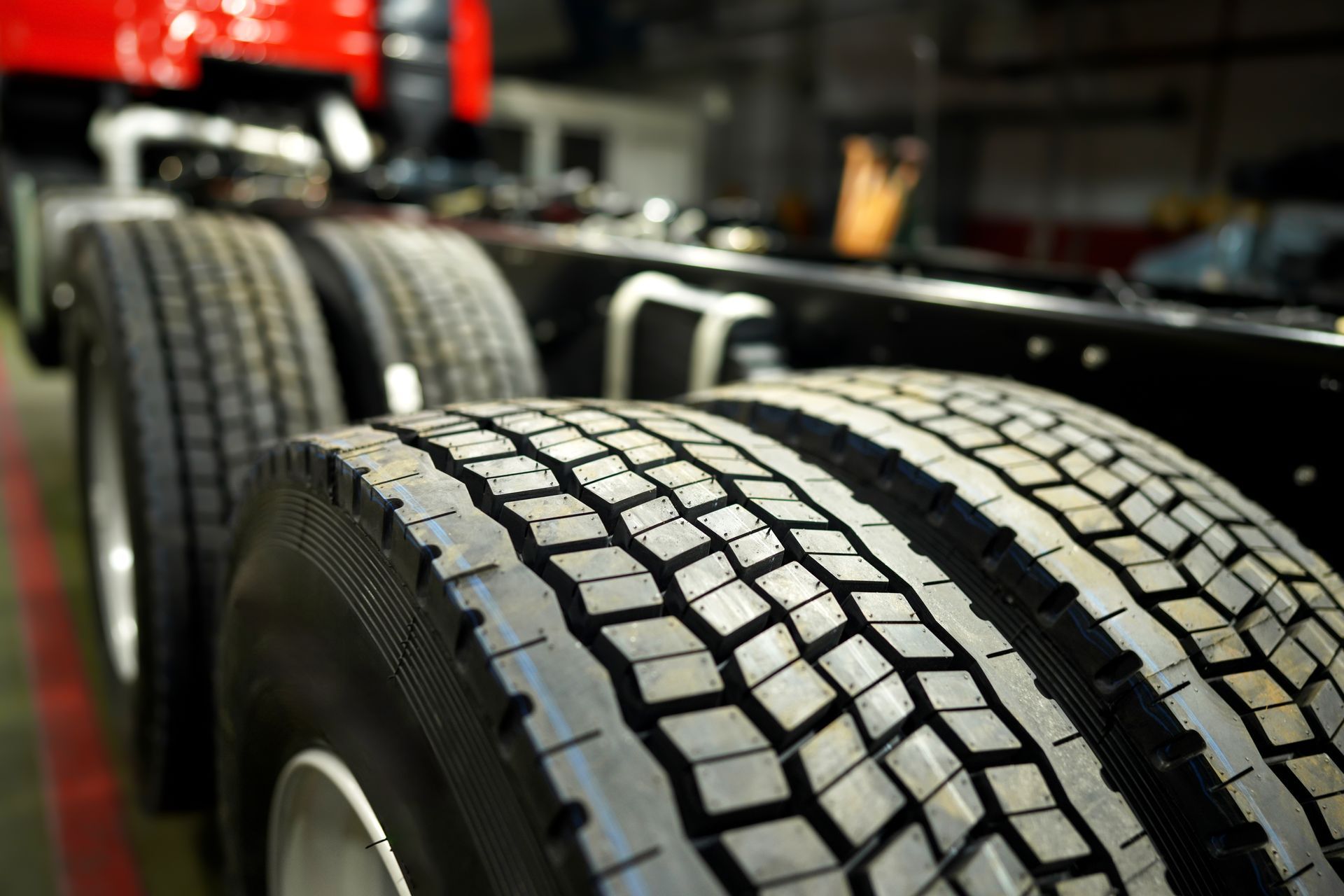 A close up of a truck 's tires in a garage.