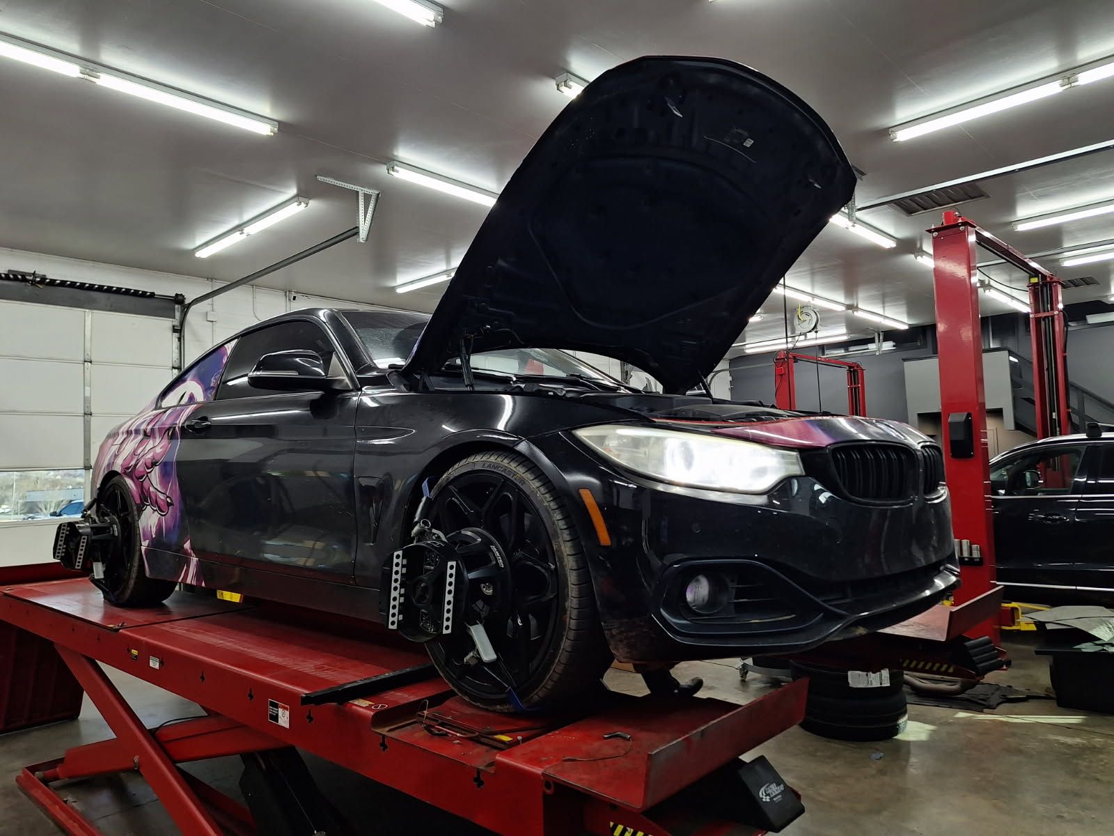 BMW On Alignment Rack Inside Repair Facility | Eurotech Knoxville