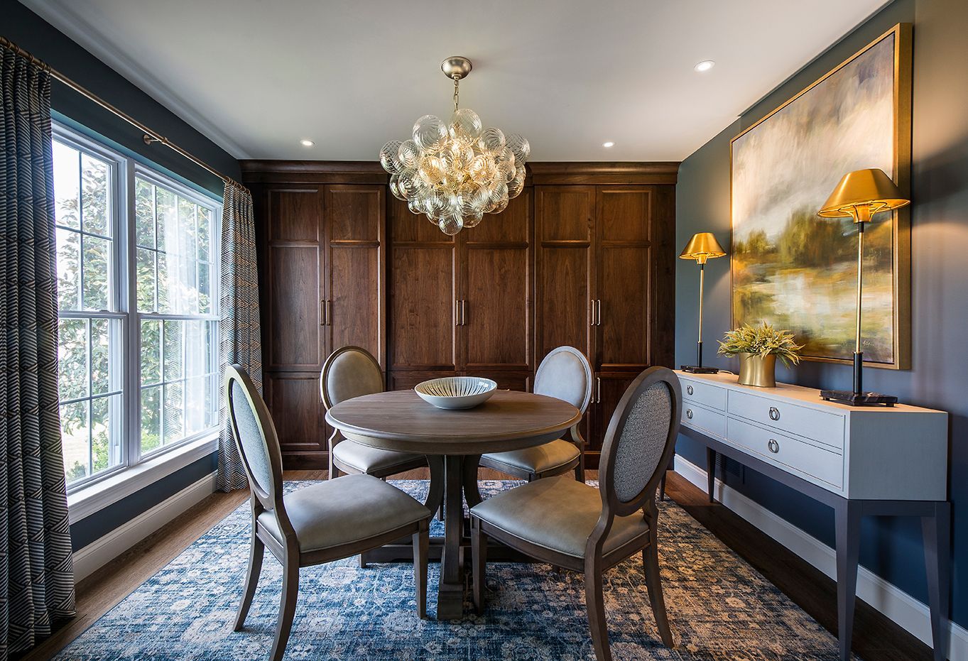 A dining room with a table and chairs and a chandelier