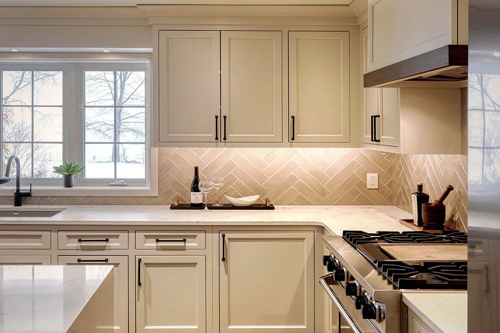 A kitchen with white cabinets and stainless steel appliances