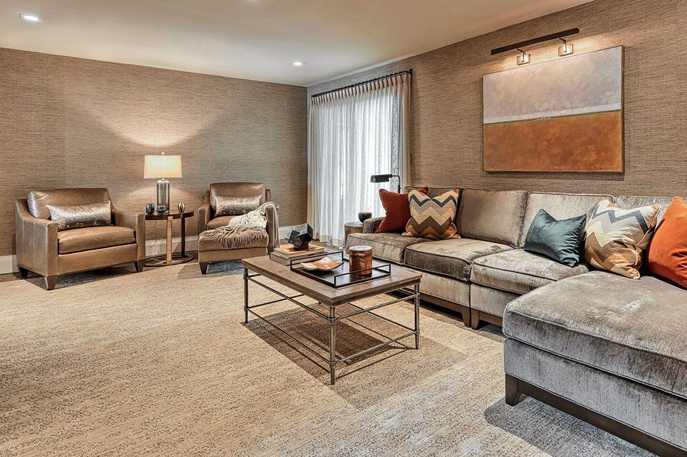 A living room with a couch and two chairs