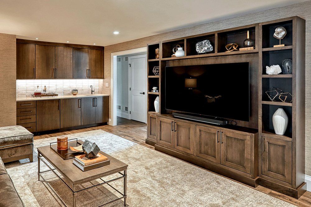 A living room with wooden cabinets and a flat screen tv