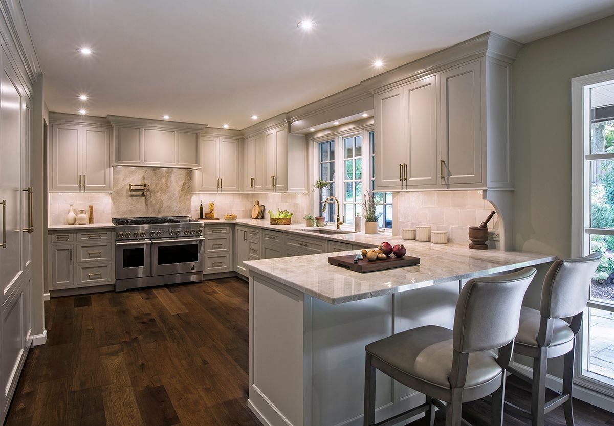 A kitchen with white cabinets and stainless steel appliances