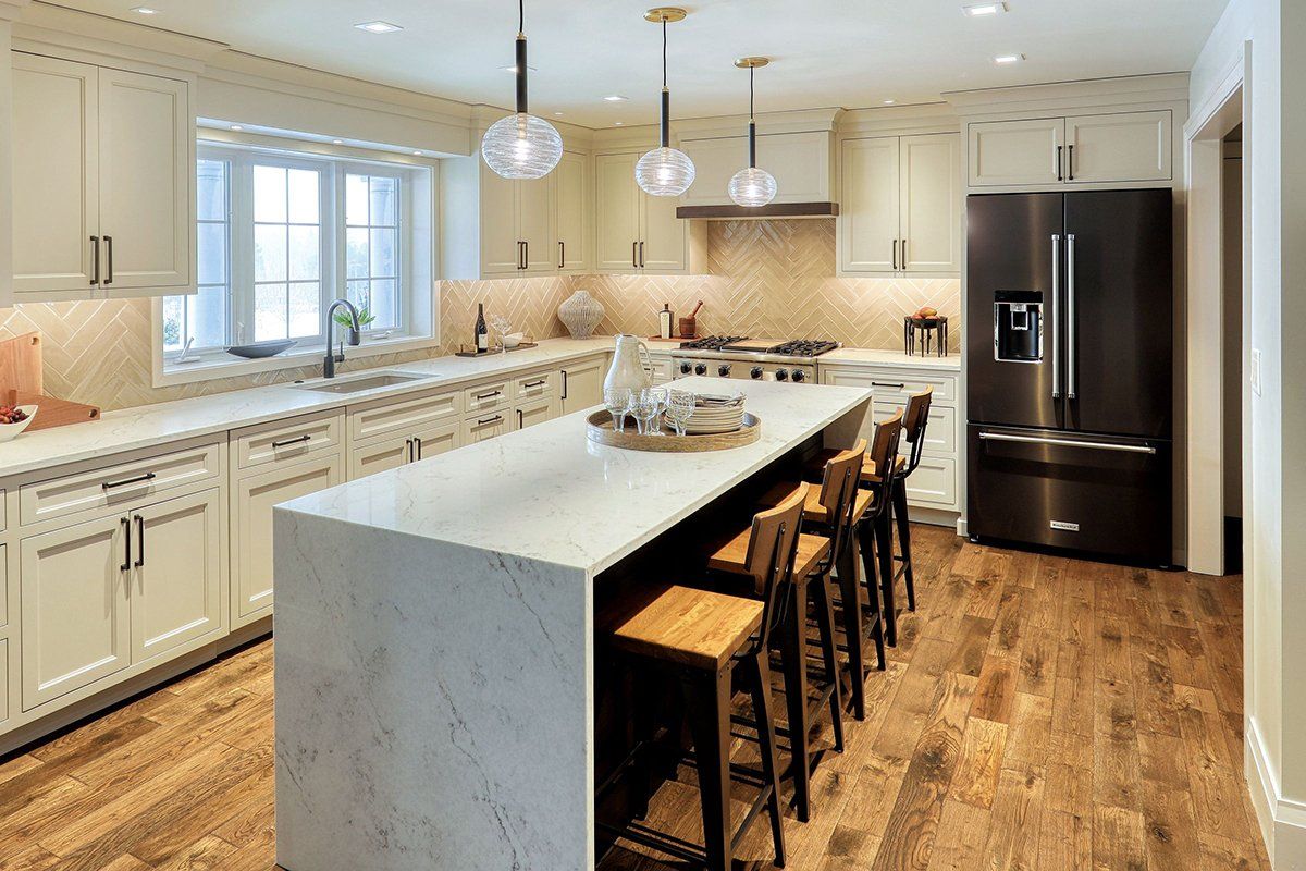 A kitchen with a large island and stools