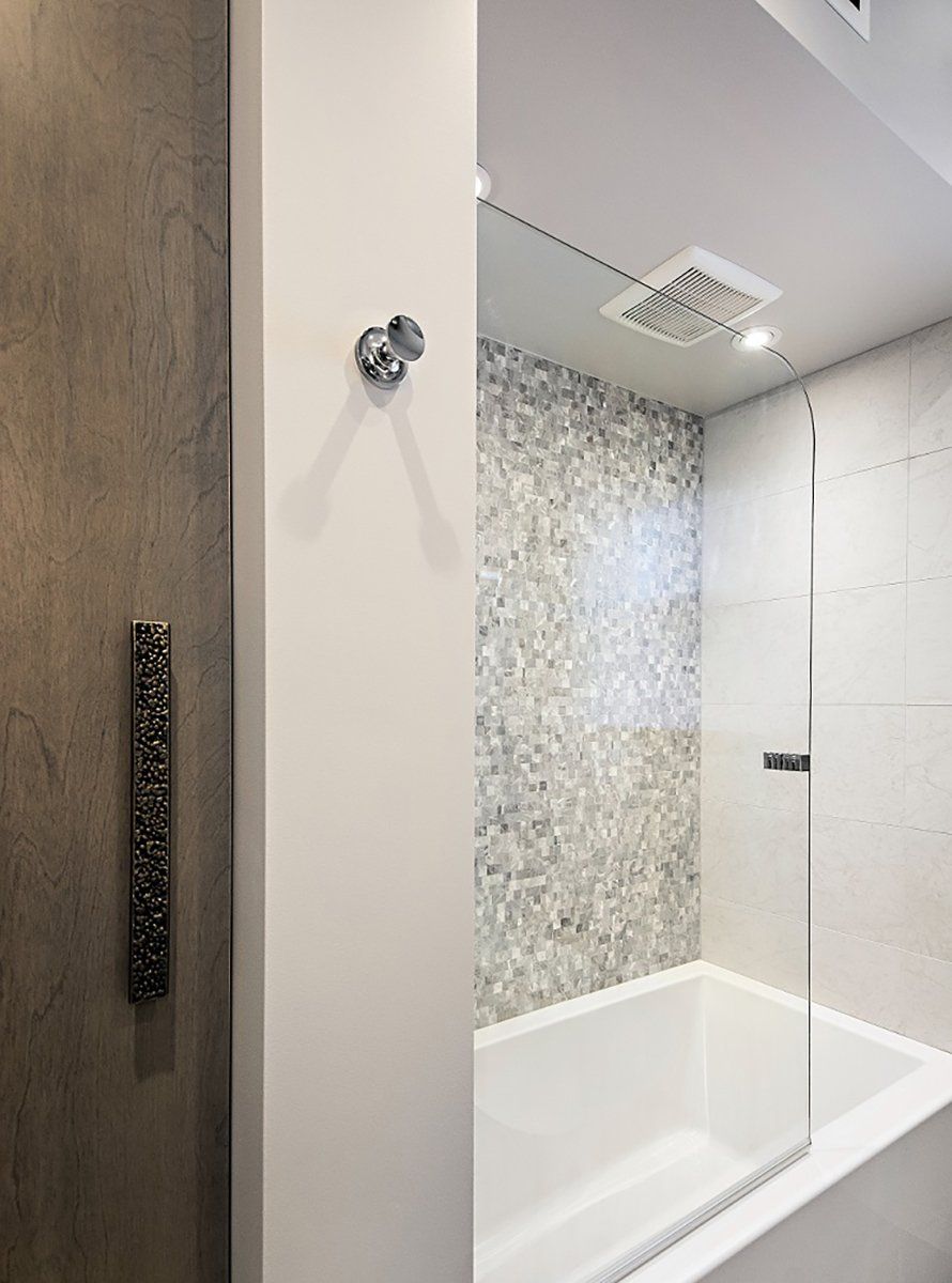 A bathroom with a bathtub and a shower