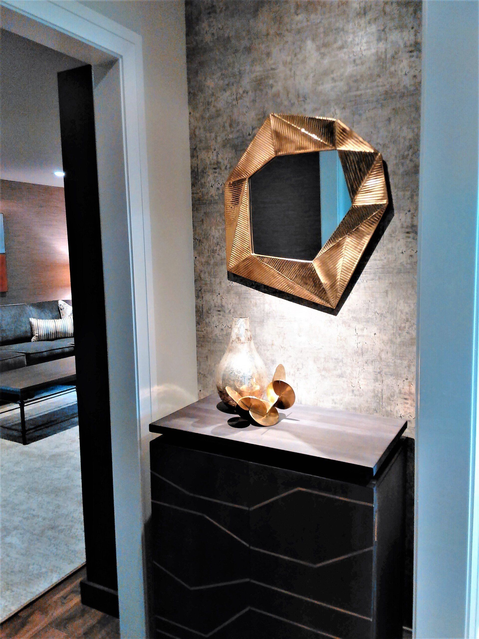 A hallway with a dresser and a mirror on the wall