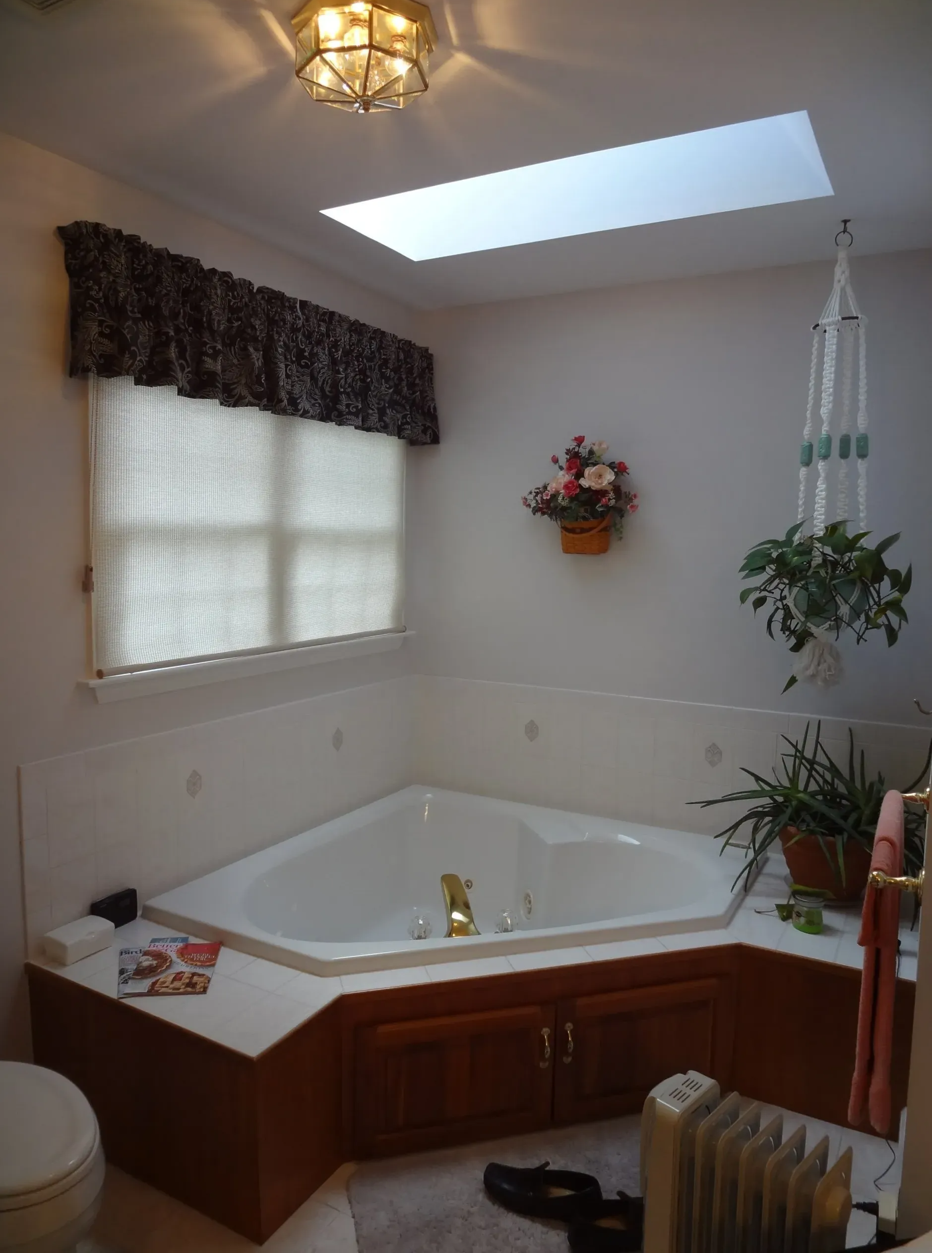 A bathroom with a jacuzzi tub and a skylight