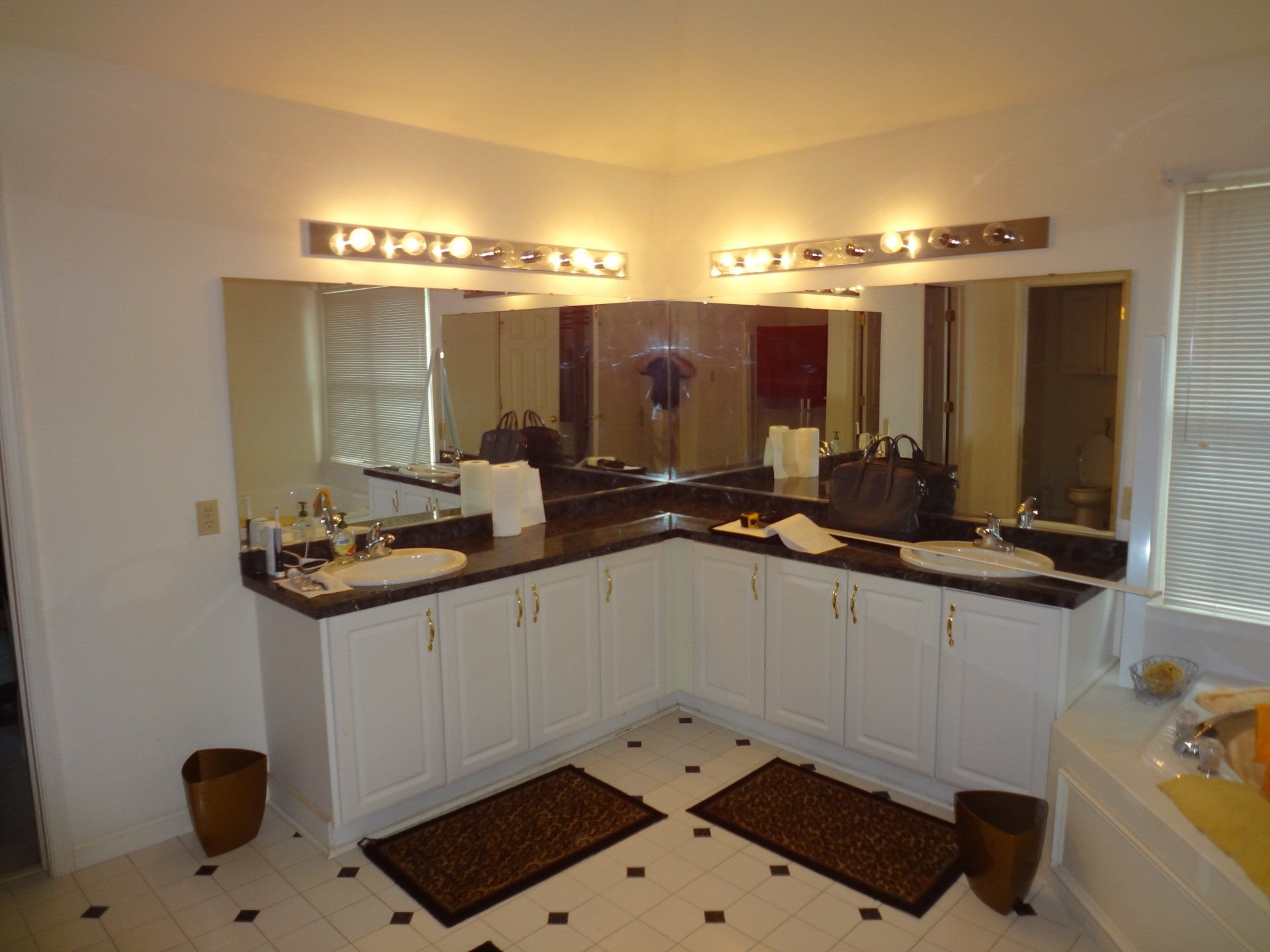 A bathroom with two sinks and two mirrors