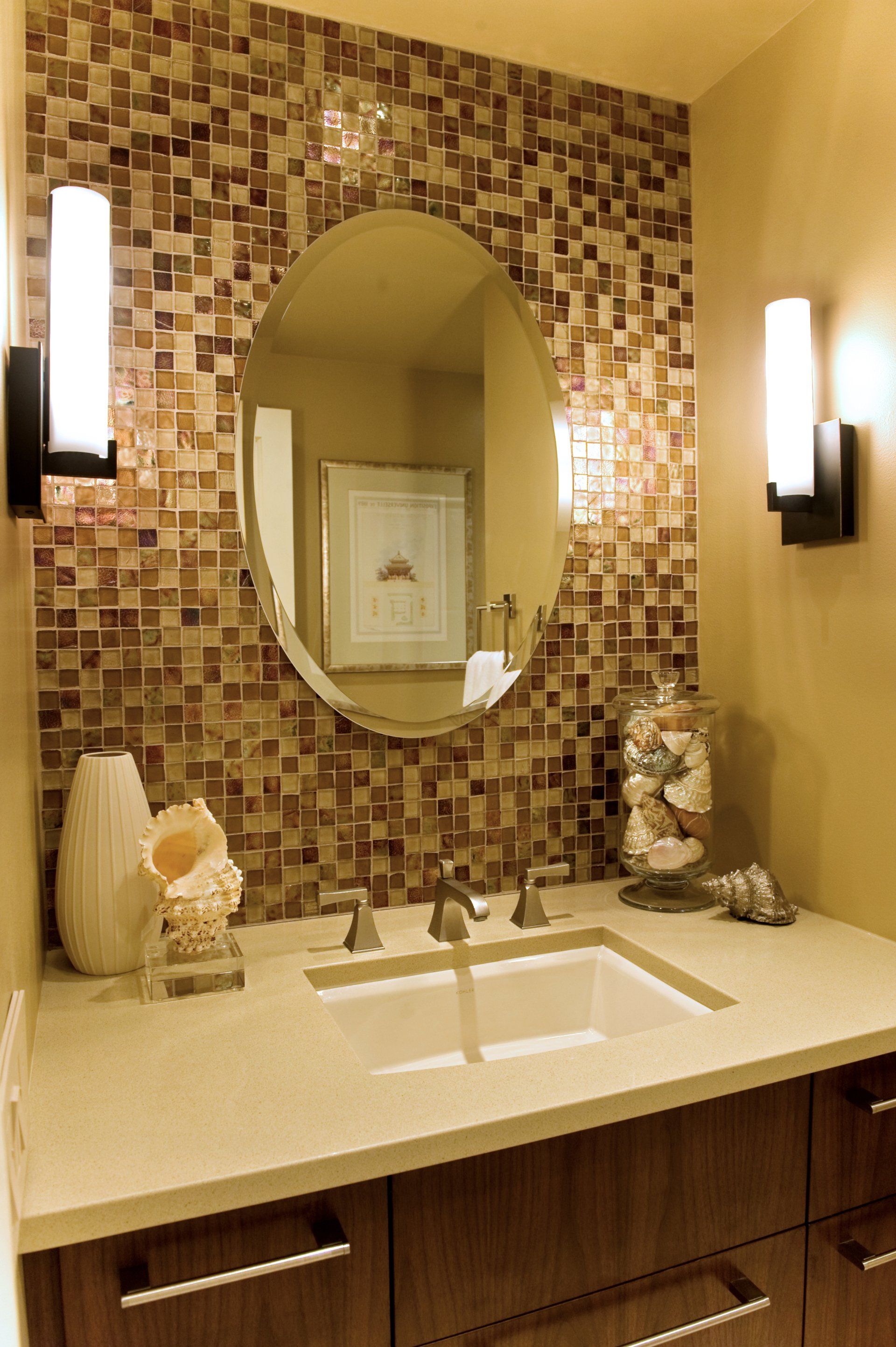 A bathroom with a round mirror and a sink