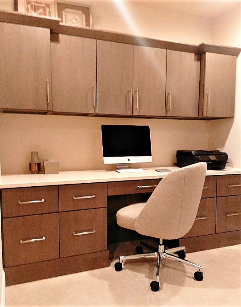 A desk with a computer on it and a chair