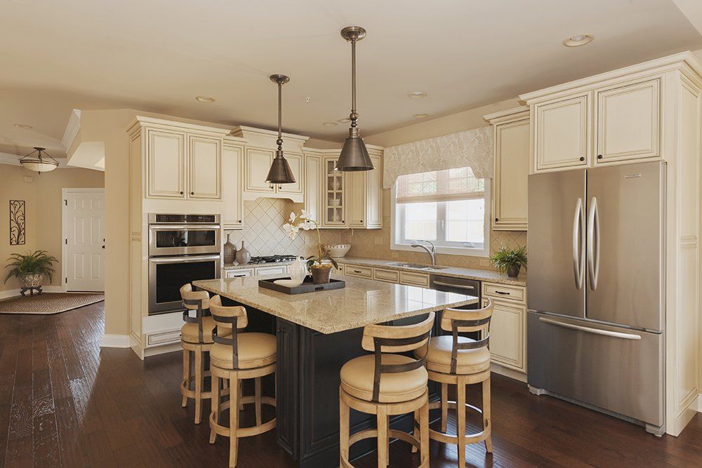 A kitchen with white cabinets and stainless steel appliances