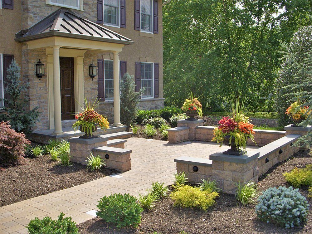A house with a brick walkway leading to the front door