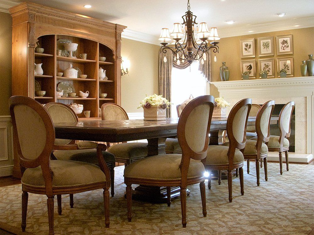 A dining room with a table and chairs and a fireplace