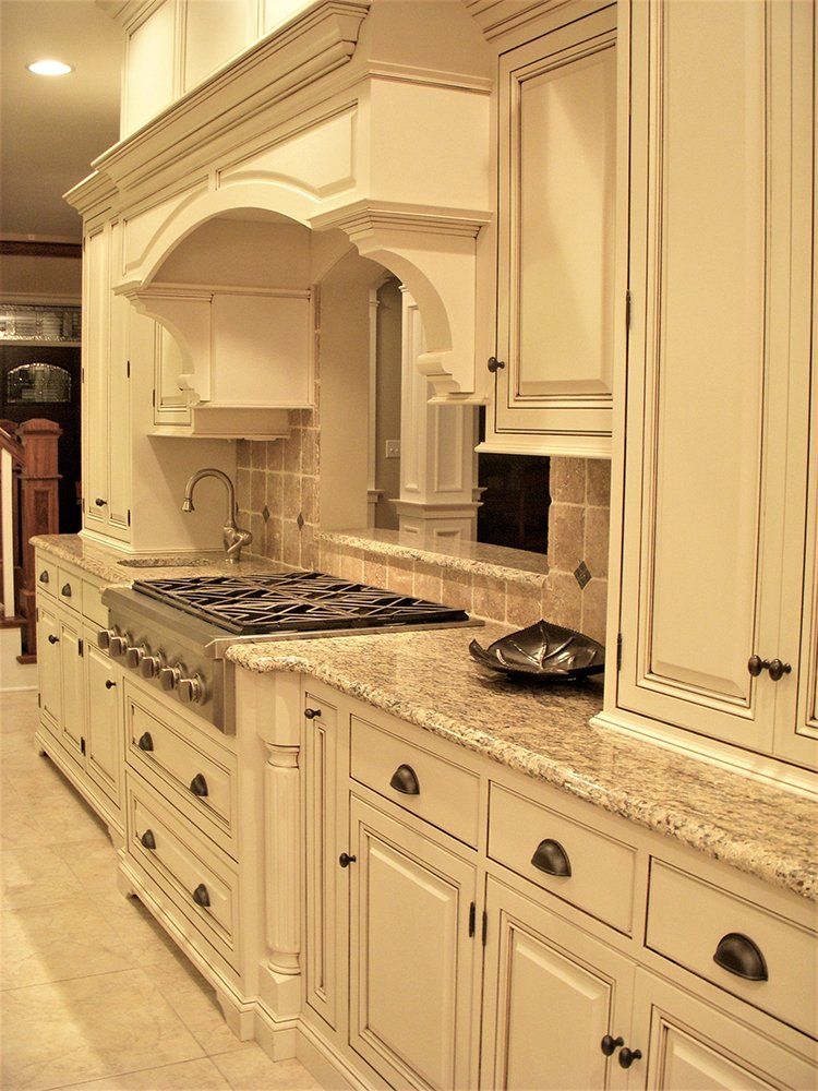 A kitchen with white cabinets and granite counter tops