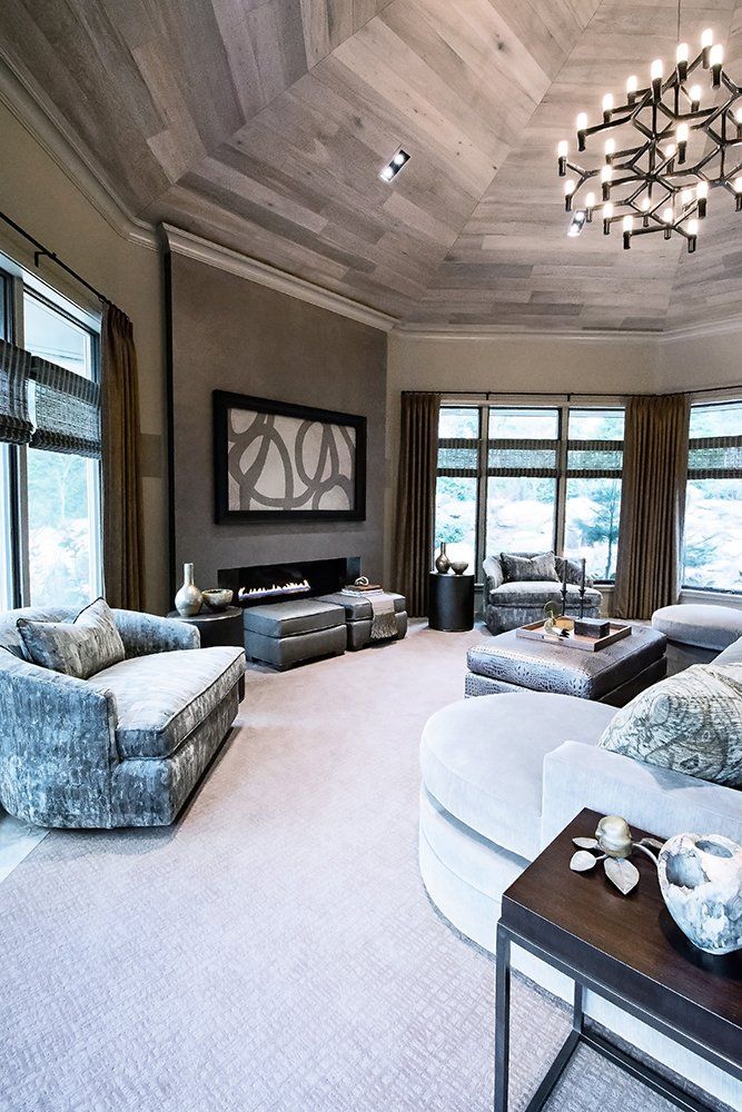 A living room with a fireplace and a chandelier