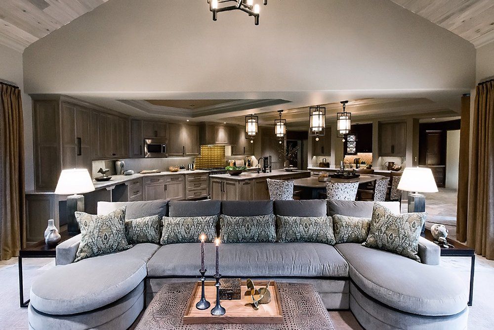 A living room with a large sectional couch and a coffee table