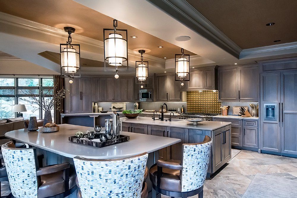 A large kitchen with a large island and chairs