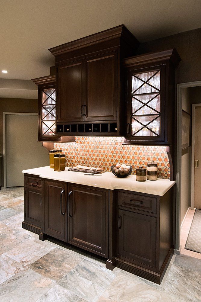 A kitchen with brown cabinets and white counter tops