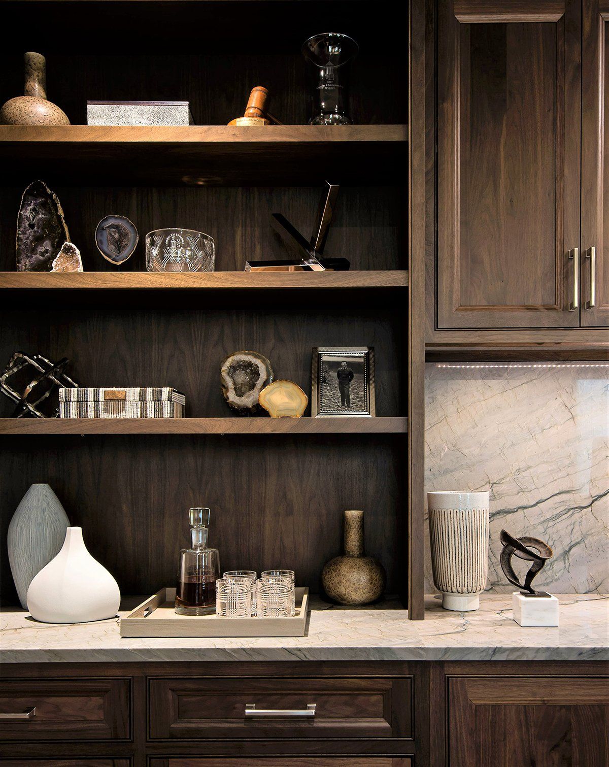 A shelf with a bottle of liquor on it