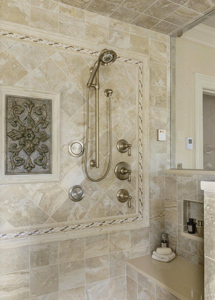 A bathroom with a walk in shower and a bench