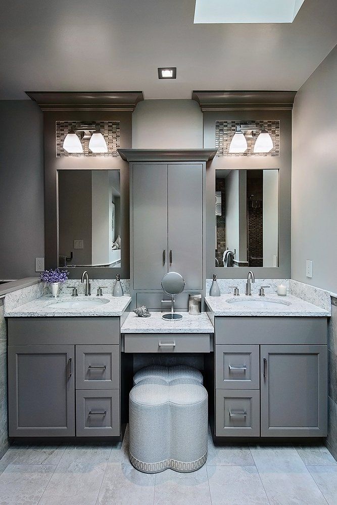 A bathroom with two sinks and two mirrors