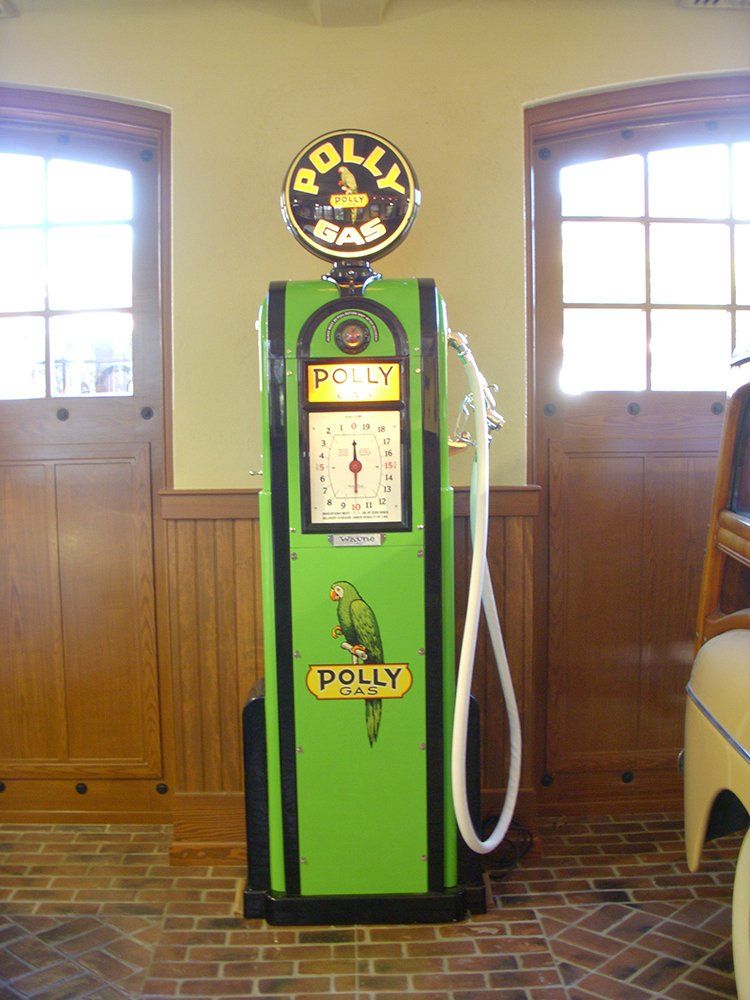 A green gas pump that says polly on it