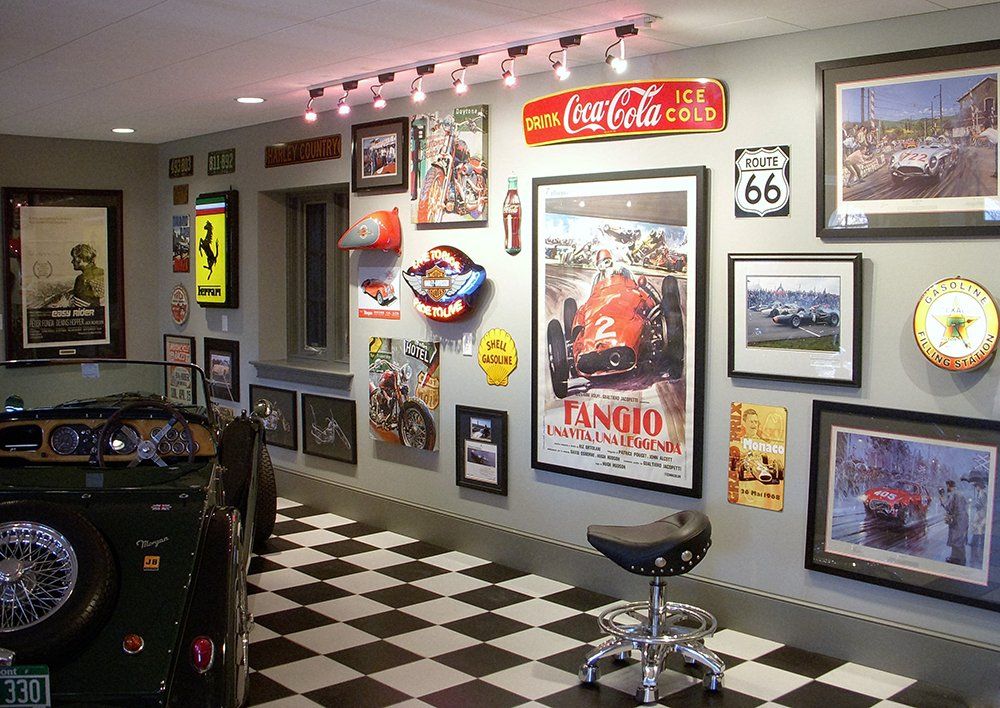 A coca cola sign hangs on a wall in a garage
