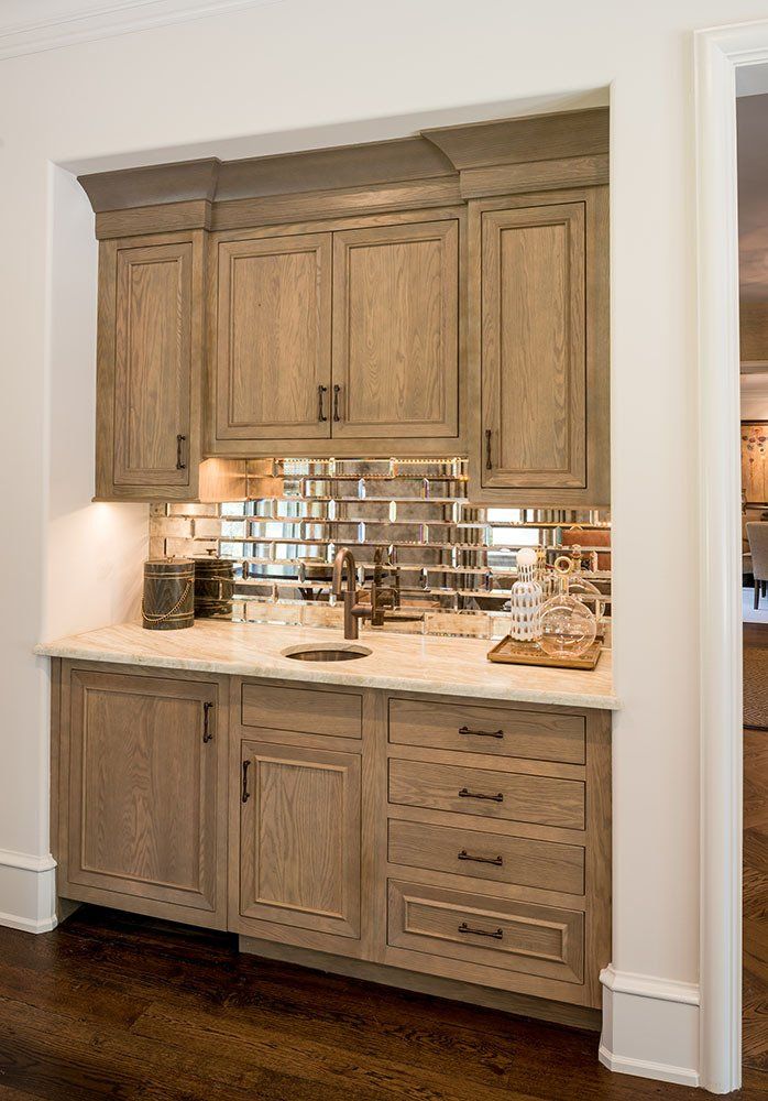 A kitchen with wooden cabinets and a sink