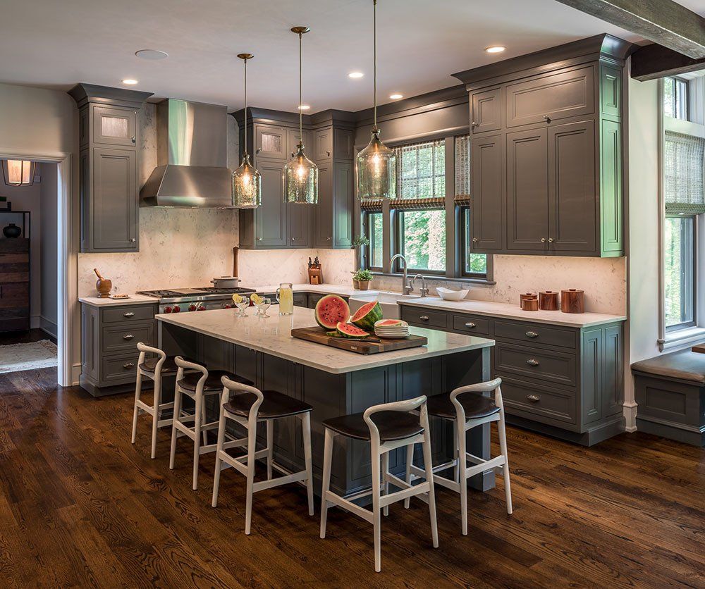 A kitchen with a large island with watermelon on it