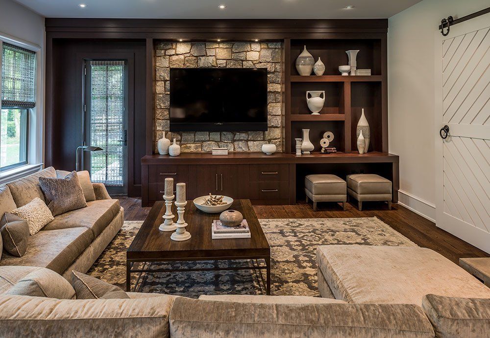 A living room with a large flat screen tv on the wall