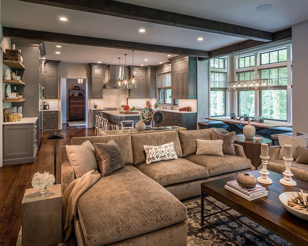 A living room with a large sectional couch and a coffee table