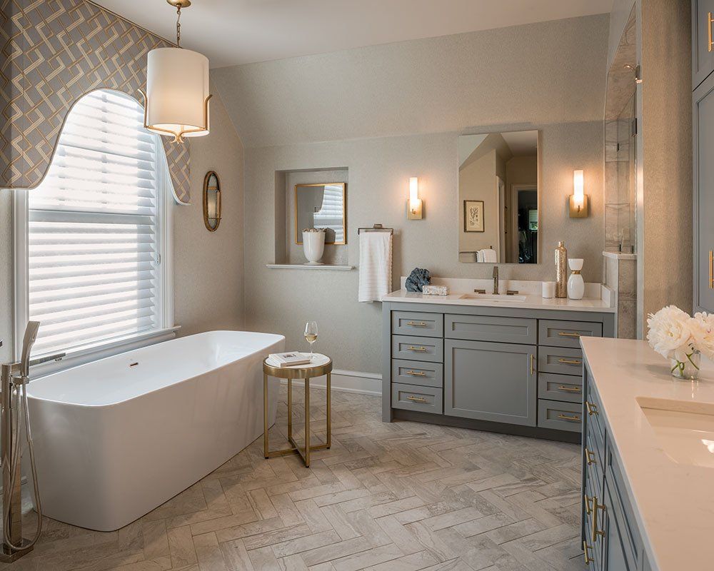 A bathroom with a bathtub and two sinks