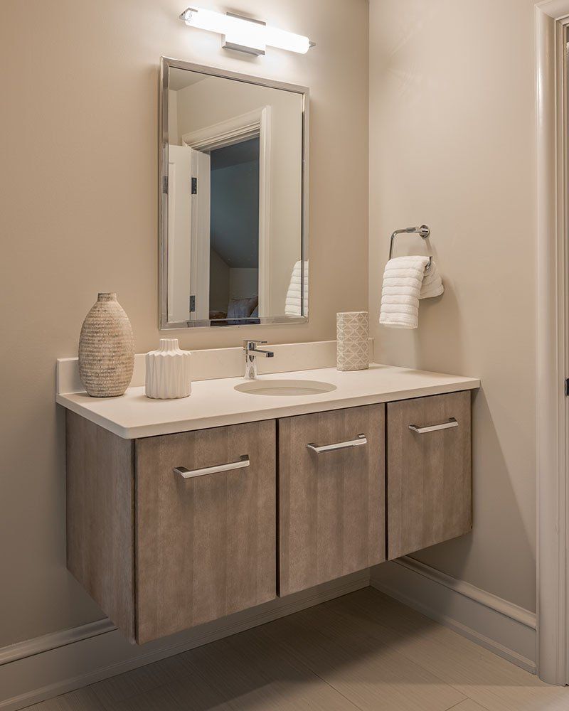 A bathroom with a sink and a mirror on the wall