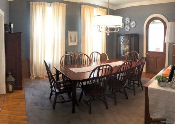 A dining room with a long table and chairs