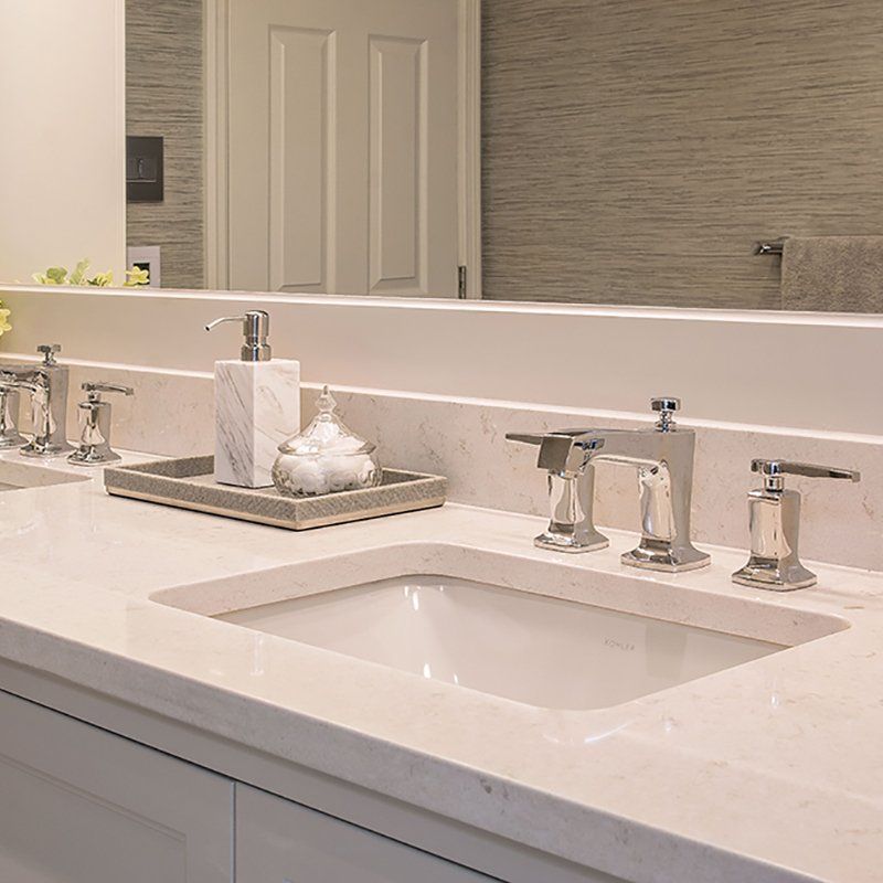 A bathroom with two sinks and a large mirror
