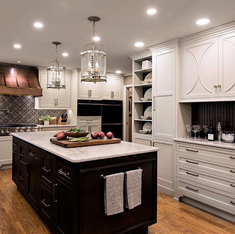 A kitchen with white cabinets and a large island