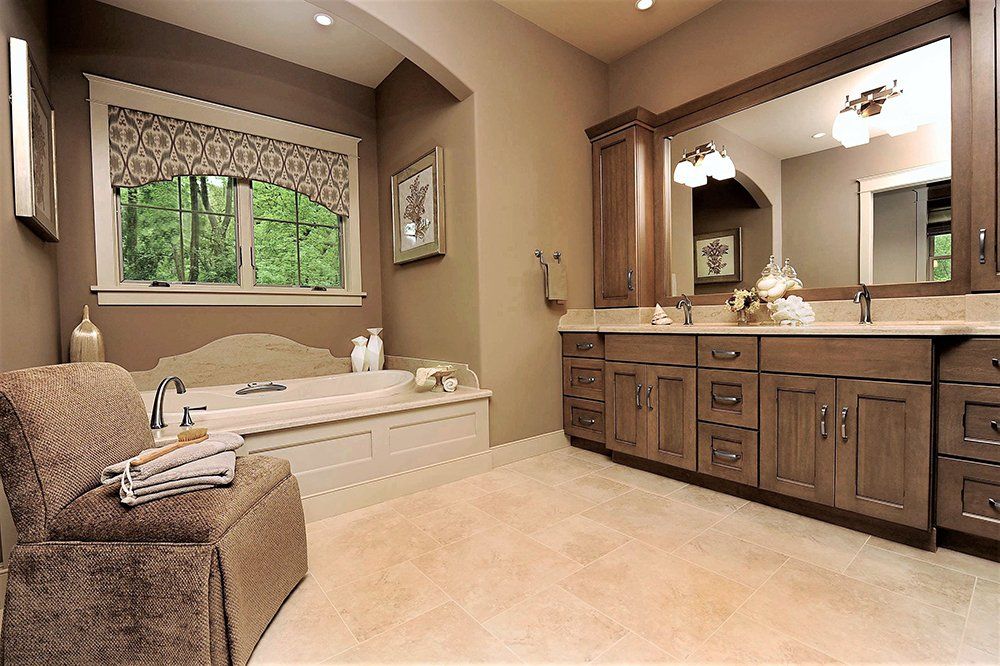 A bathroom with a large tub and two sinks