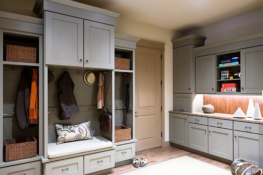 A laundry room with lots of cabinets and drawers