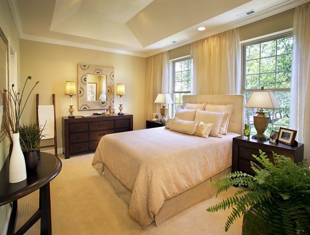 A bedroom with a large bed and a dresser