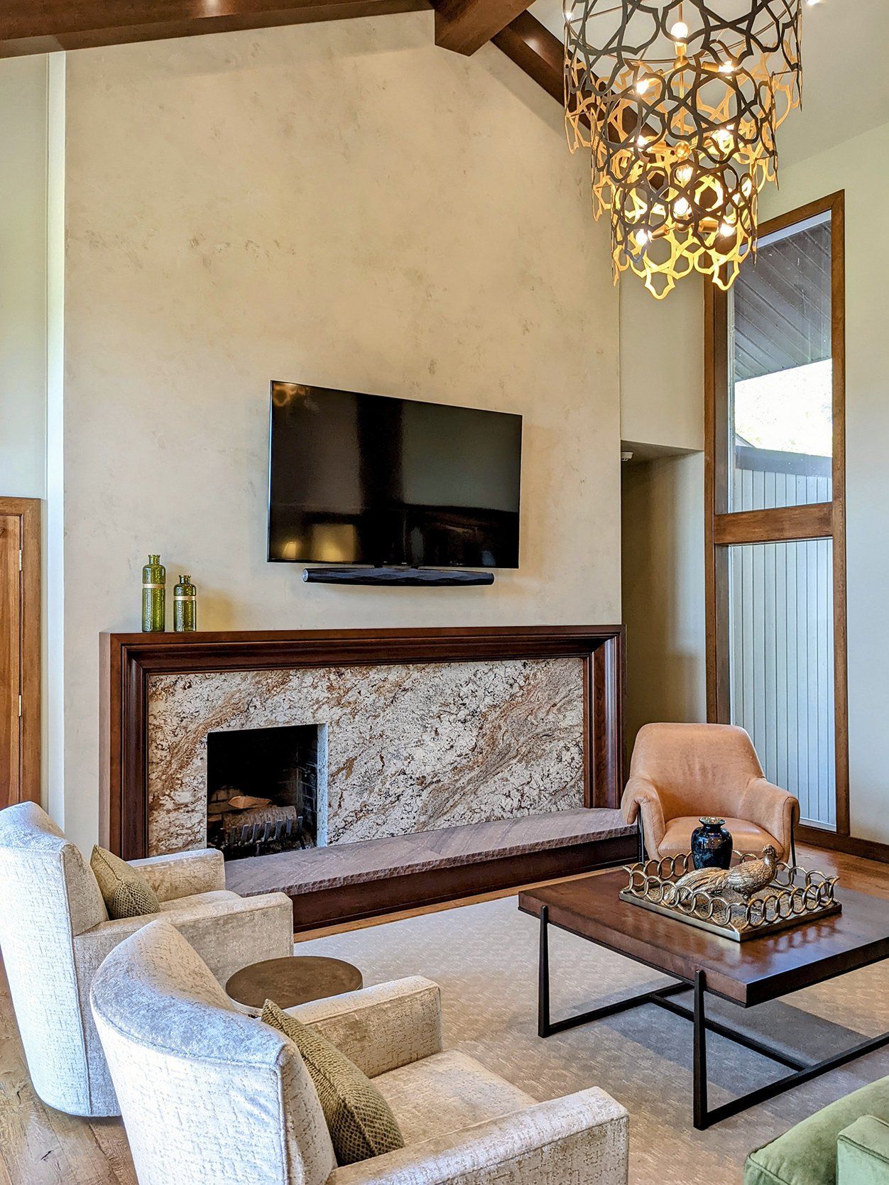A living room with a fireplace and a flat screen tv