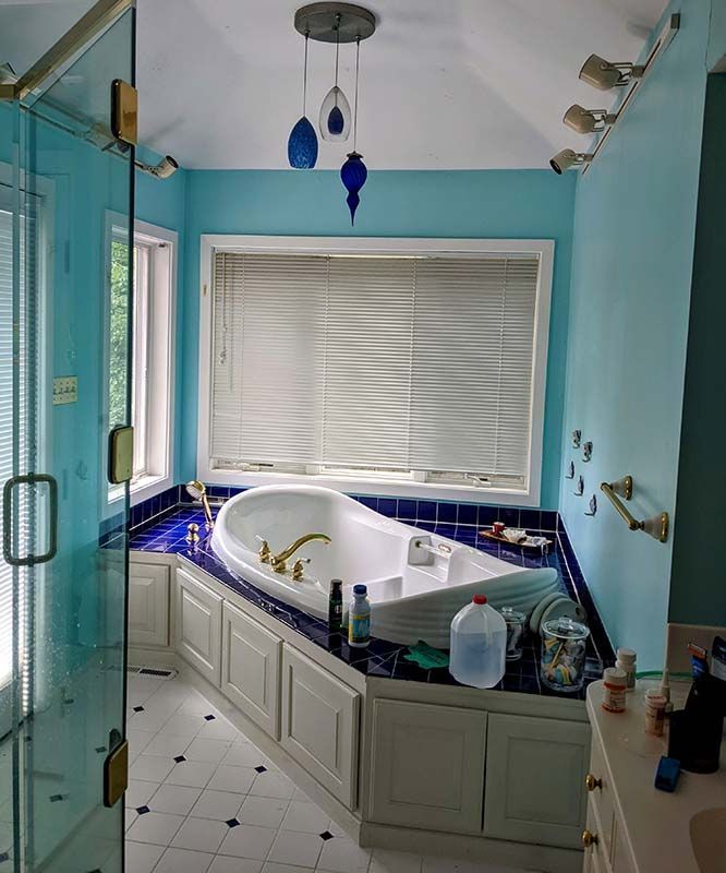 A bathroom with blue walls and a jacuzzi tub