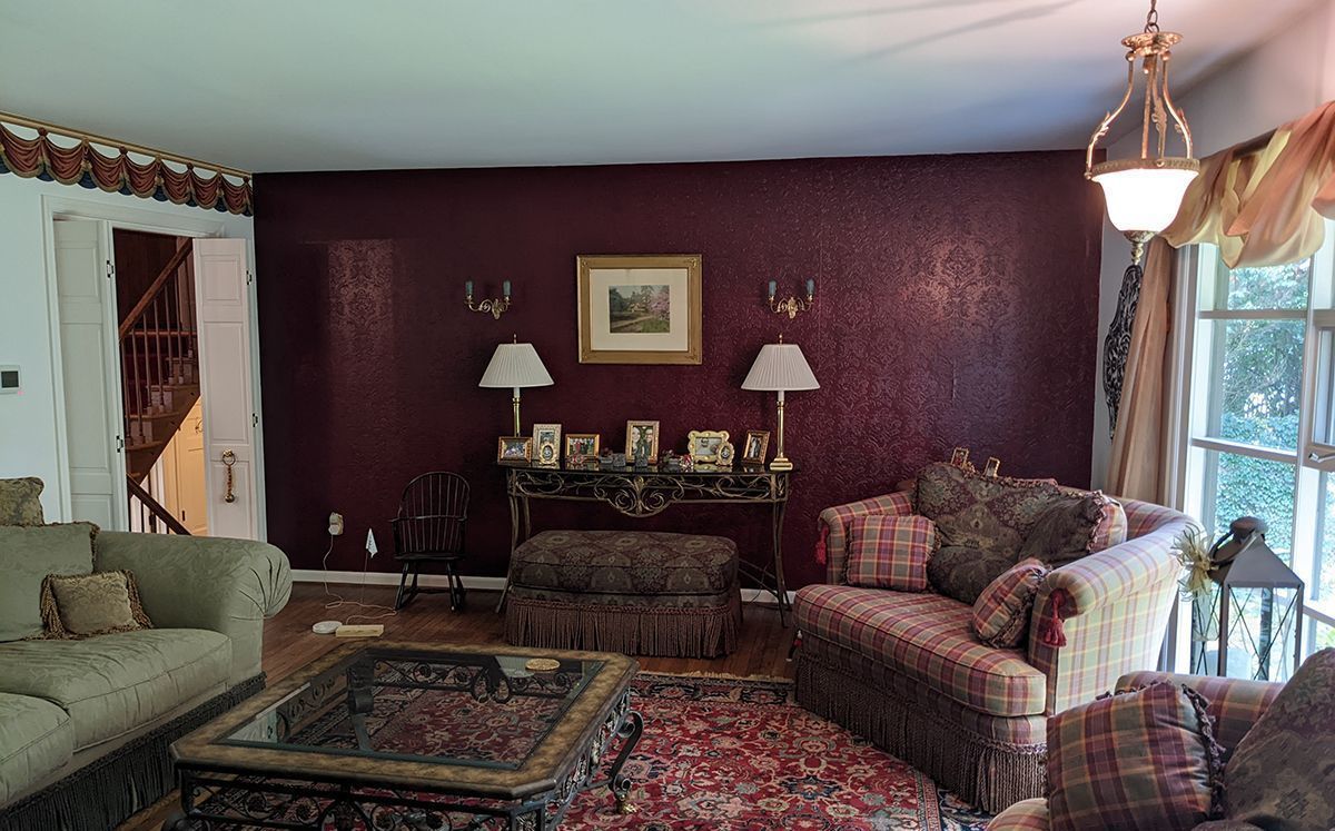 A living room filled with furniture and a picture on the wall