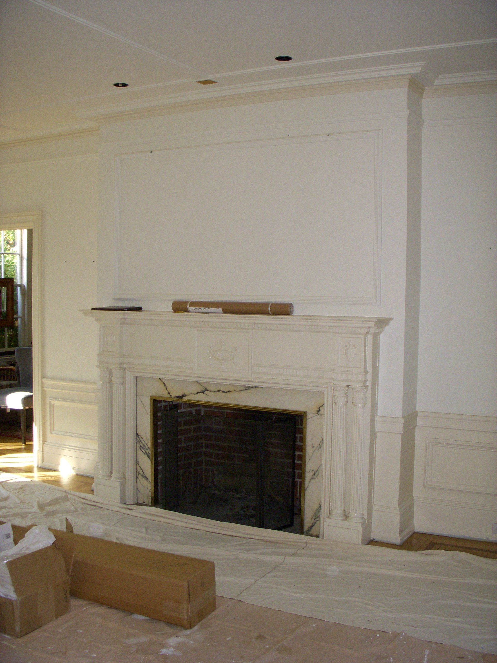 A fireplace in a room with white walls