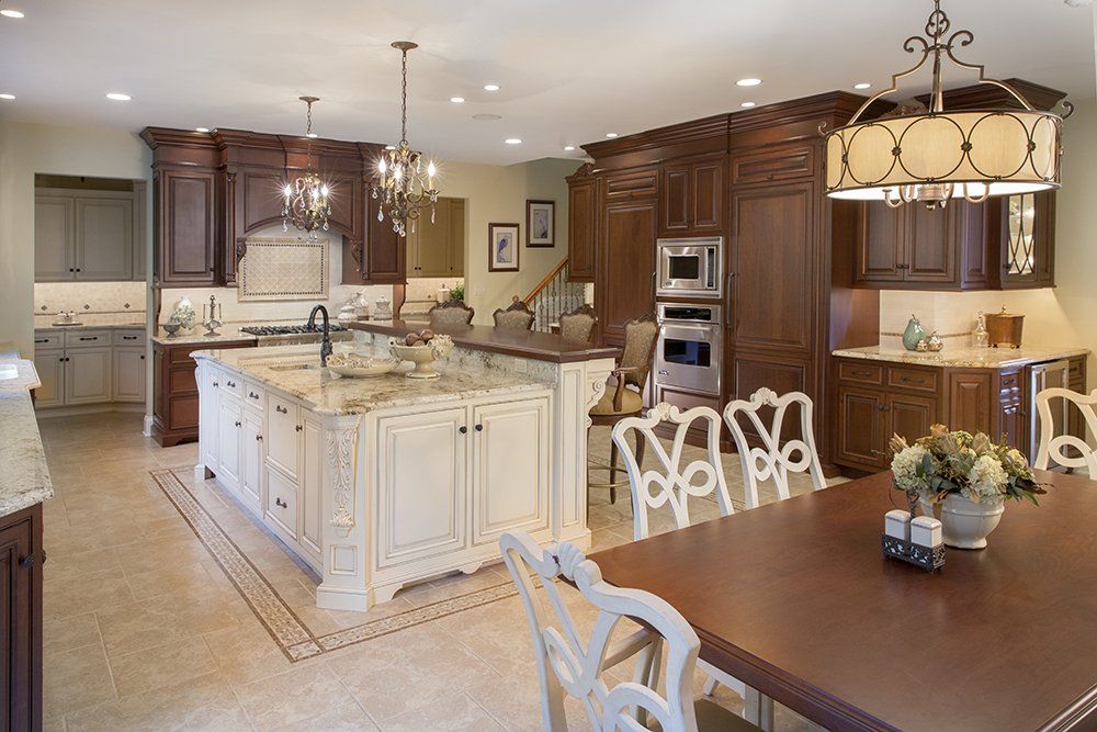 A kitchen with white cabinets and a large island