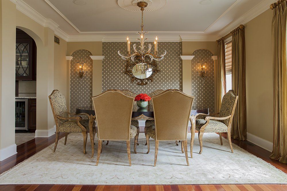 A dining room with a table and chairs and a chandelier