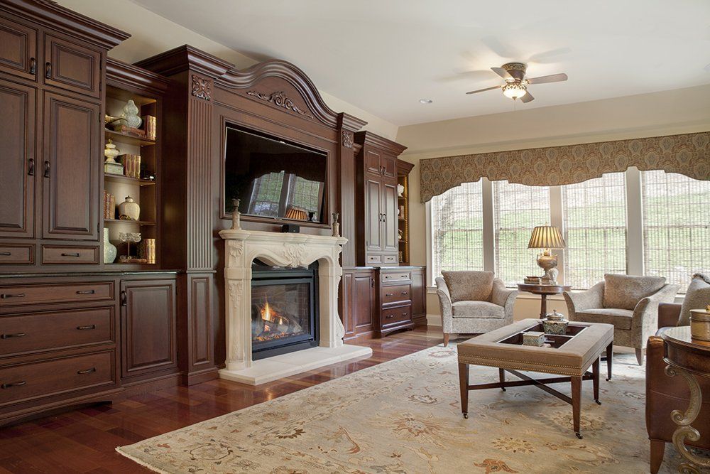 A living room with a fireplace and a ceiling fan