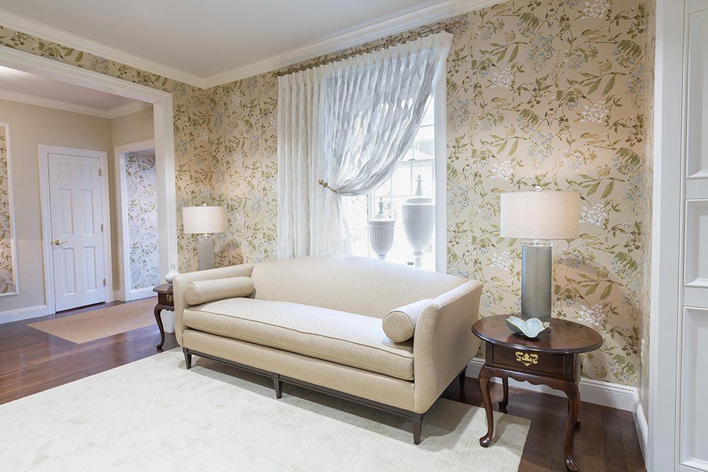 A living room with a couch and two lamps